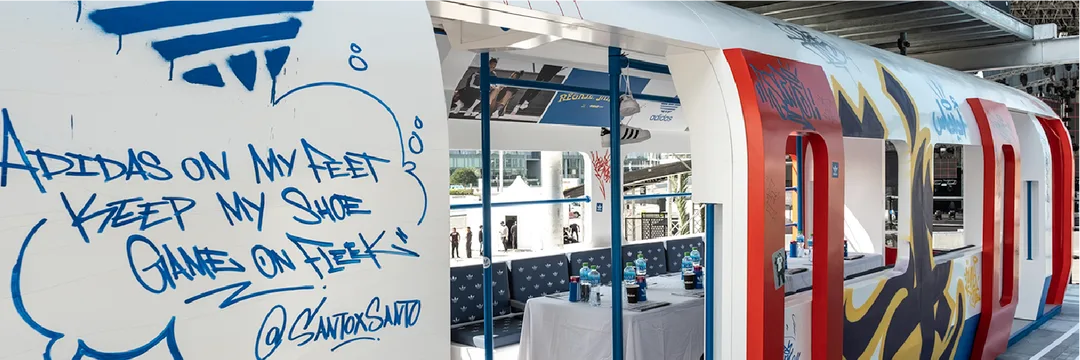 A three-level Adidas pavilion inspired by the London Underground combined immersive urban design, retail displays and an elevated VIP view of the festival stage.