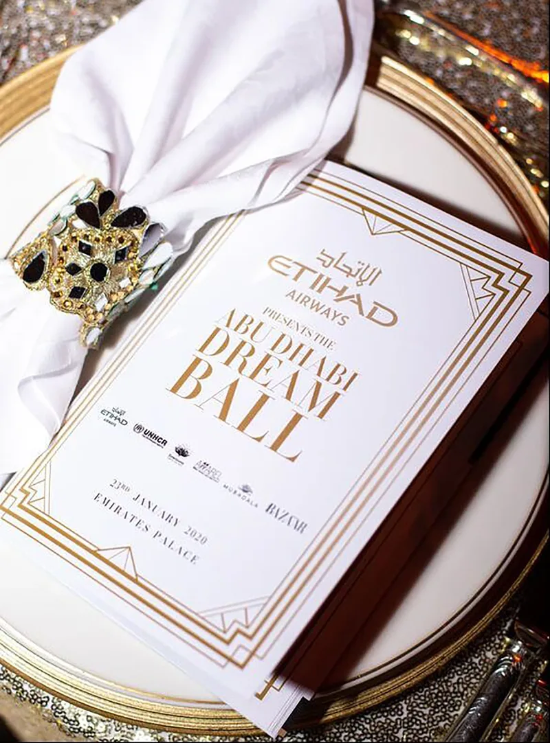 Abu Dhabi Dream Ball programme styled with a bespoke jewelled napkin ring.