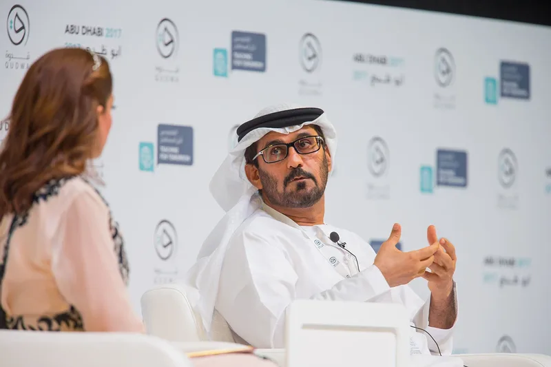 Panellists discussing education reform before a seated international audience