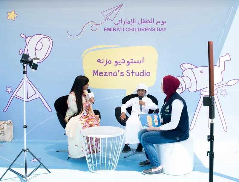 Emirati Children’s Day interview at Mezna’s Studio featuring a young participant, presenter and facilitator on a branded set