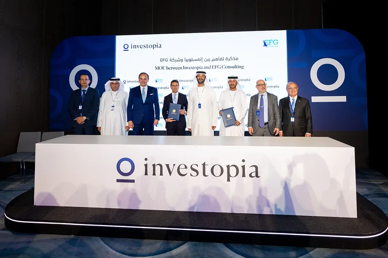 Investopia and EFG Consulting representatives at a branded memorandum signing ceremony