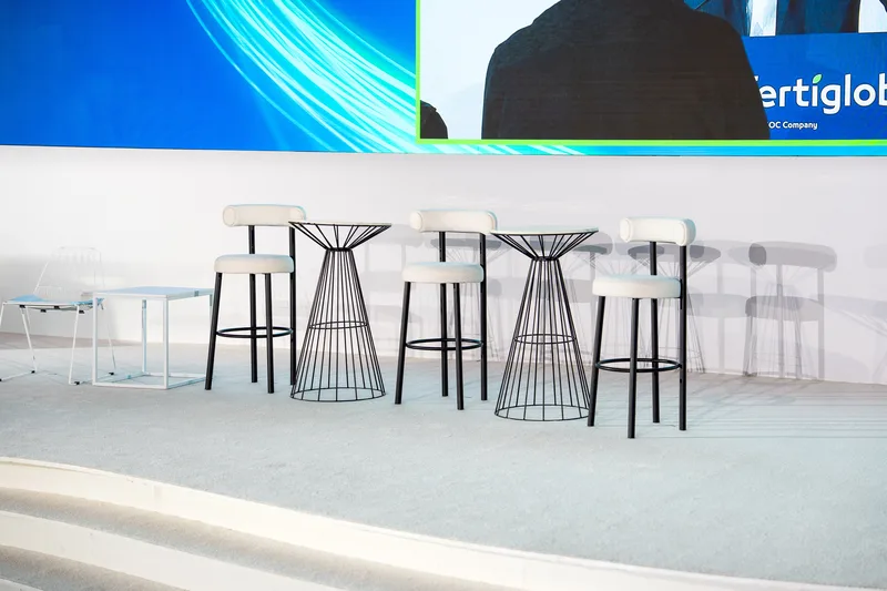 Catering networking buffet area with high-top tables and minimalist stool seating