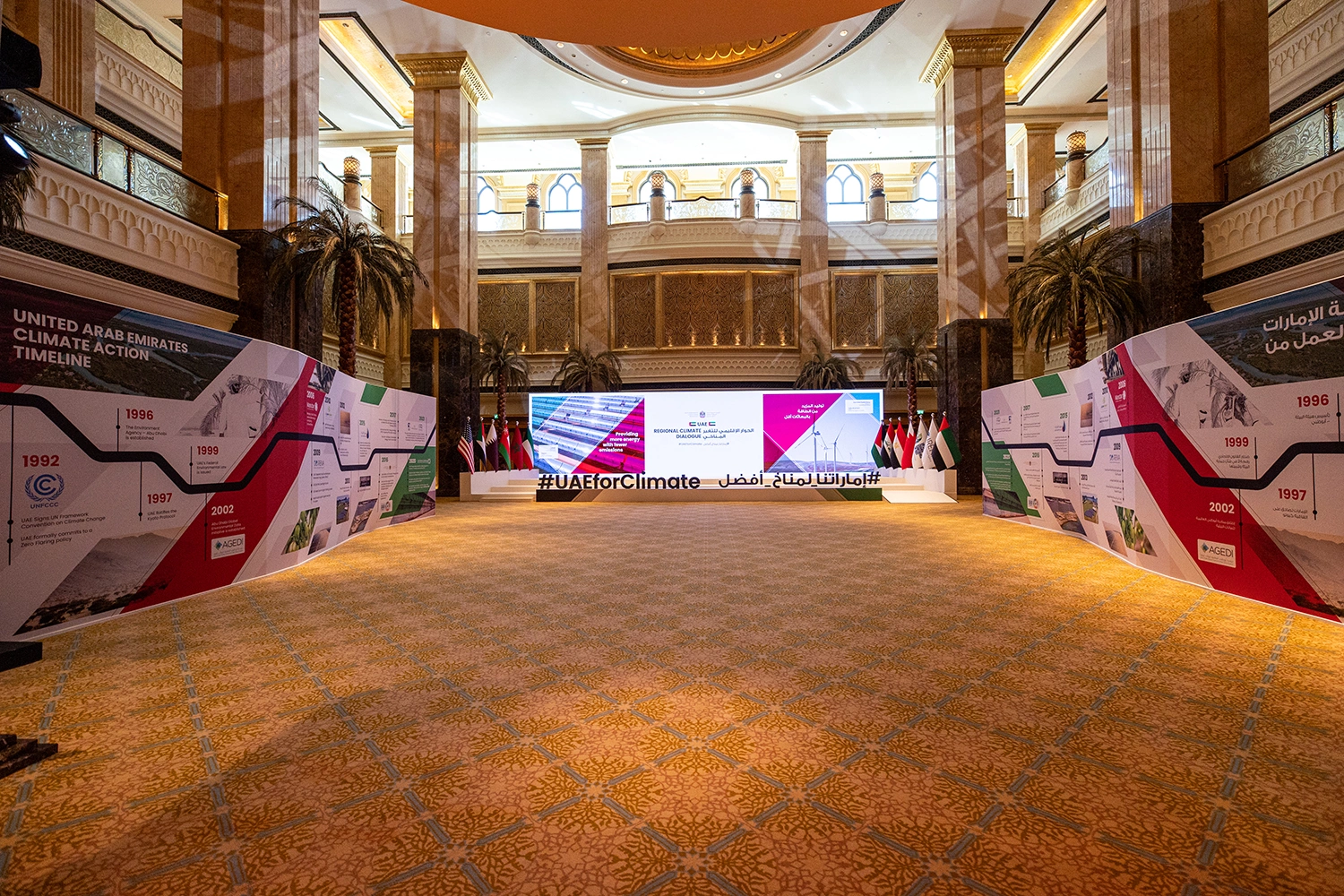 Evolution Scenic climate dialogue entrance installation with timeline walls, flags and central LED screen