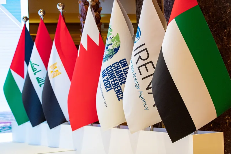Evolution Events flag display featuring regional delegations, IRENA and UN climate branding