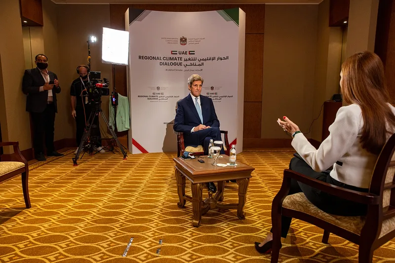 Evolution Events branded interview set with broadcast camera, lighting and seated climate dialogue speakers