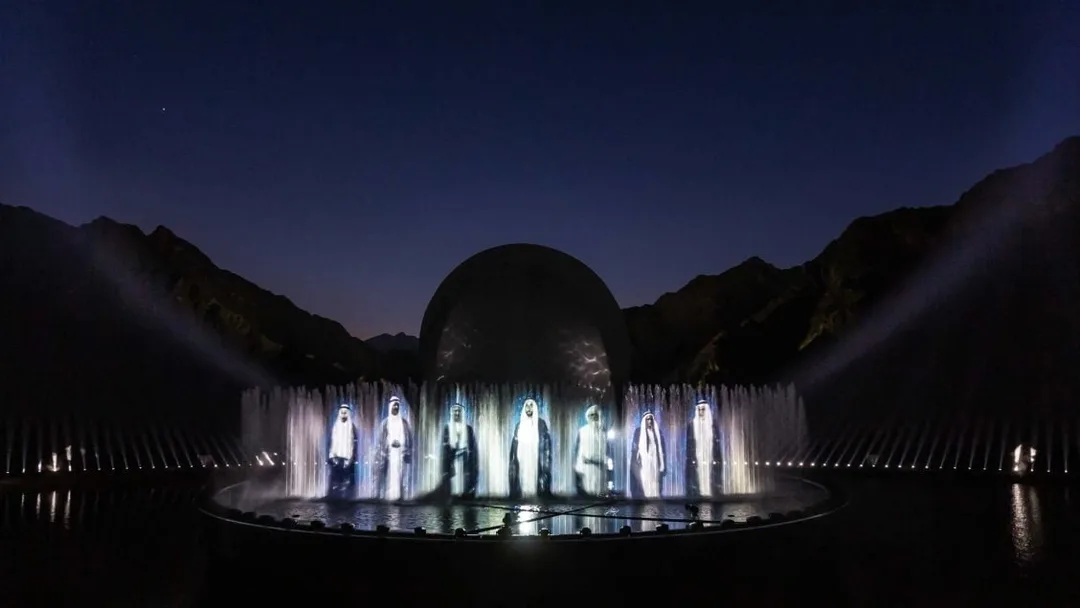 Massive curved water screen projection system displaying historical UAE documentary visuals