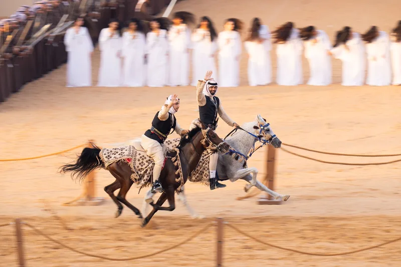 Traditional camel and horse parade procession performing in front of spectators
