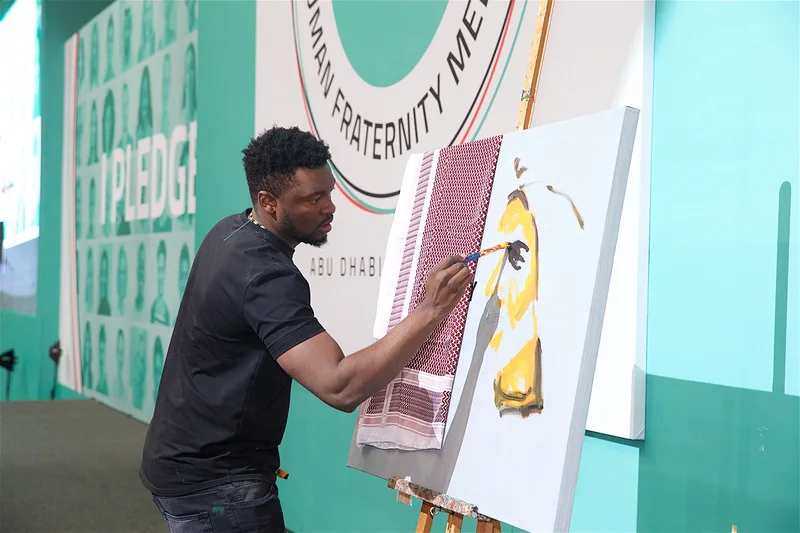 Youth Tolerance Rally stage featuring a live performance, multicultural portrait backdrop and tolerance-themed artwork