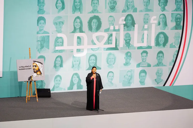 Youth Tolerance Rally stage featuring a live performance, multicultural portrait backdrop and tolerance-themed artwork